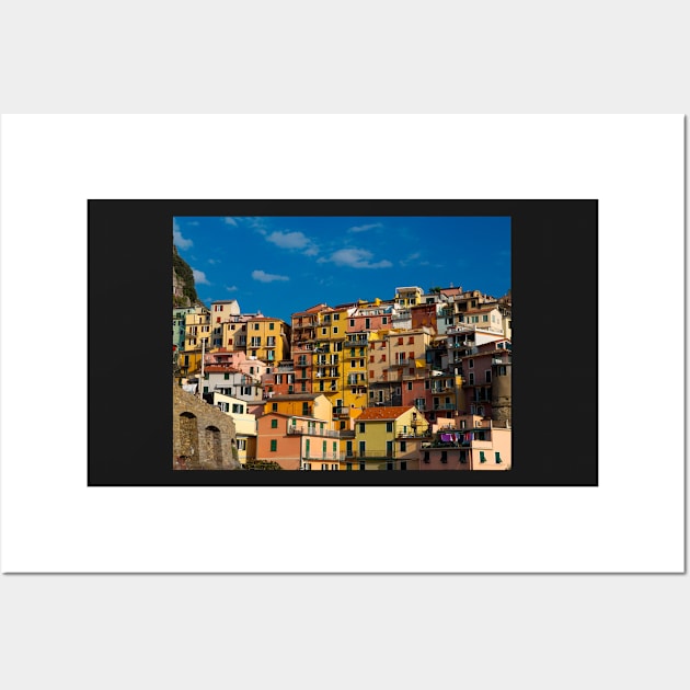 View on the cliff town of Manarola, one of the colorful Cinque Terre on the Italian west coast Wall Art by Dolfilms